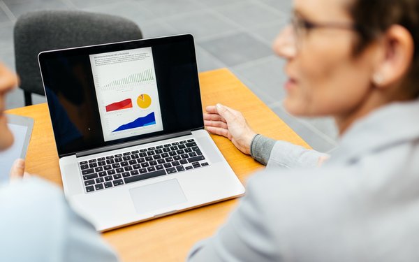 Menschen besprechen eine Statistik am Laptop