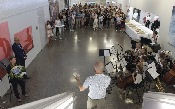 Visitors to the Summer Festival 2023; view from above of speakers and audience in the Building for Music and Art