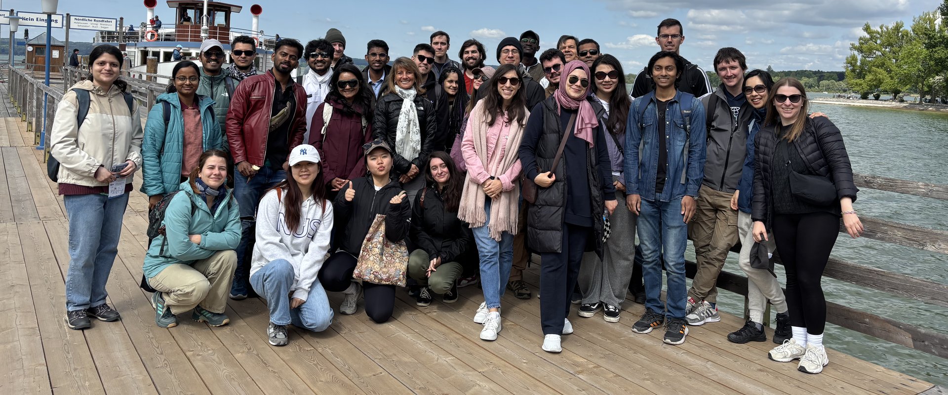 A group of international researchers posing on the jetty at Lake Ammersee