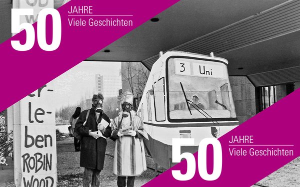 Zwei Studierende protestieren für den Bau der Straßenbahnlinie mit Halt Universität in Augsburg.