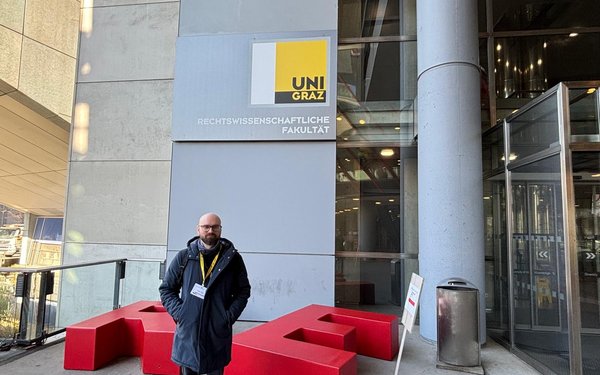 Stefano steht in der Halle der Uni Graz