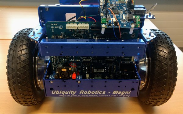 wheeled robot from the front, shows active development with a microcontroller and dangling wires