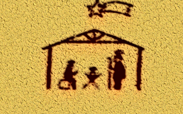 Eine Zeichnung einer einfachen Krippe in schwarz auf einem goldenen Hintergrund.