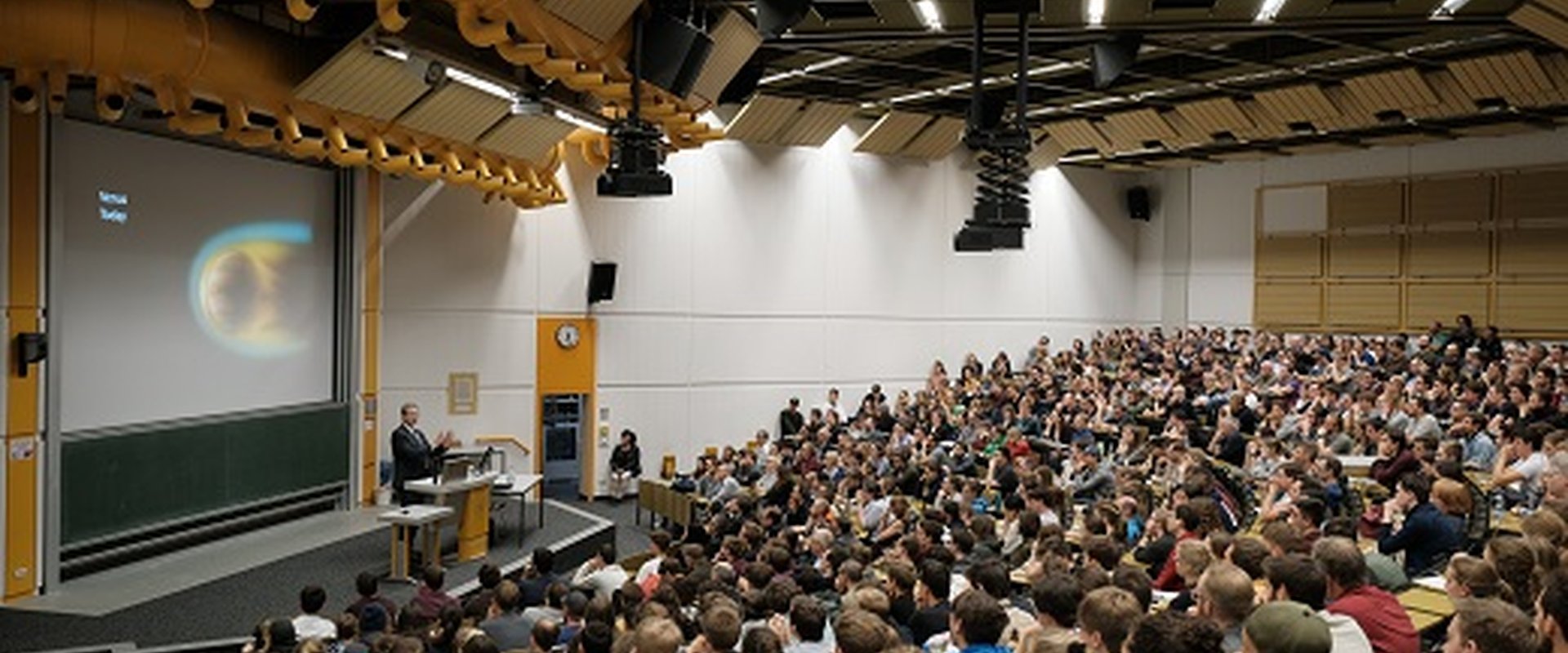 Speaker and full auditorium