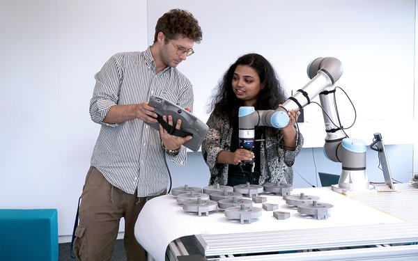 Pooja Prajod discusses the experimental setup with Matteo Lavit Nicora
