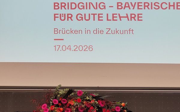 Logo und Blumenschmuck beim bayerischen Tag der guten Lehre