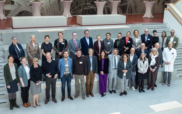 Menschengruppe steht auf Treppe f��r ein Gruppenbild